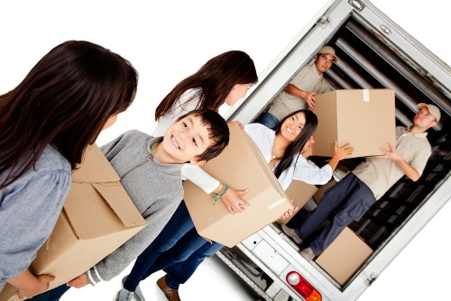 Professional movers loading furniture into a moving van