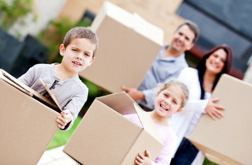 Moving crew carrying furniture down a stairwell during a house move