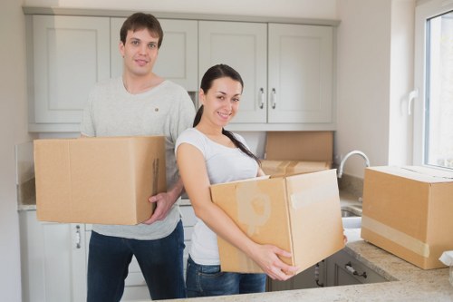 Volunteers loading donated household items onto a low-emission moving van